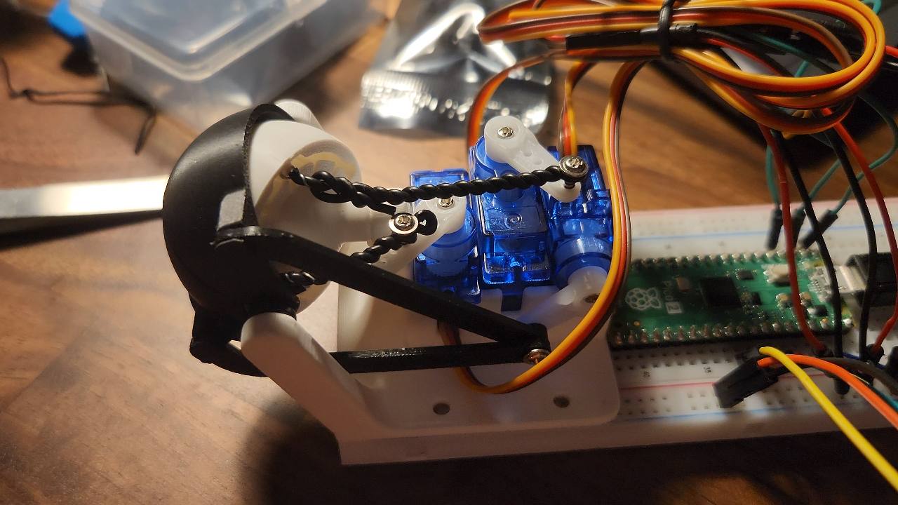 Servo motors and 3D-printed linkages inside an eye mechanism prototype
