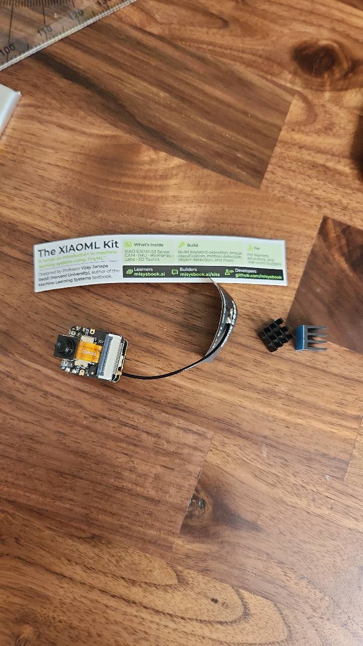 XIAOML compact camera module and connector on a wooden desk