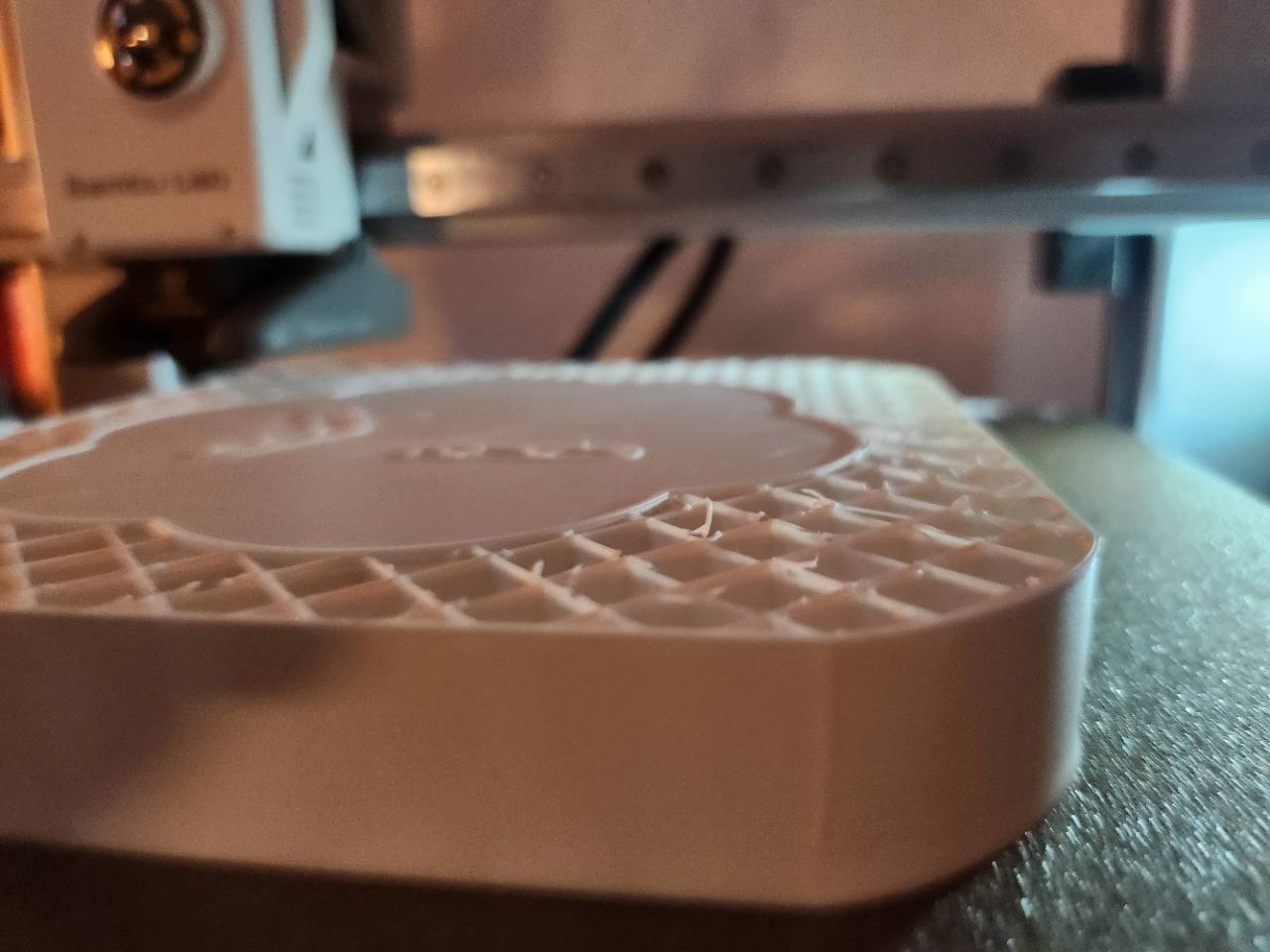 White base for a physical Codex mark being fabricated on a 3D printer